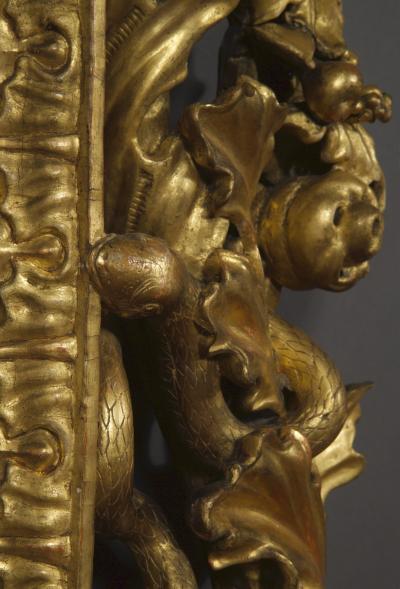 A BAROQUE ACANTHUS GILTWOOD MIRROR CARVED WITH UNUSUAL SERPENT