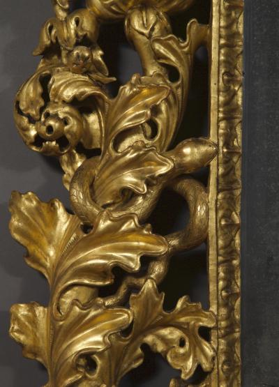 A BAROQUE ACANTHUS GILTWOOD MIRROR CARVED WITH UNUSUAL SERPENT