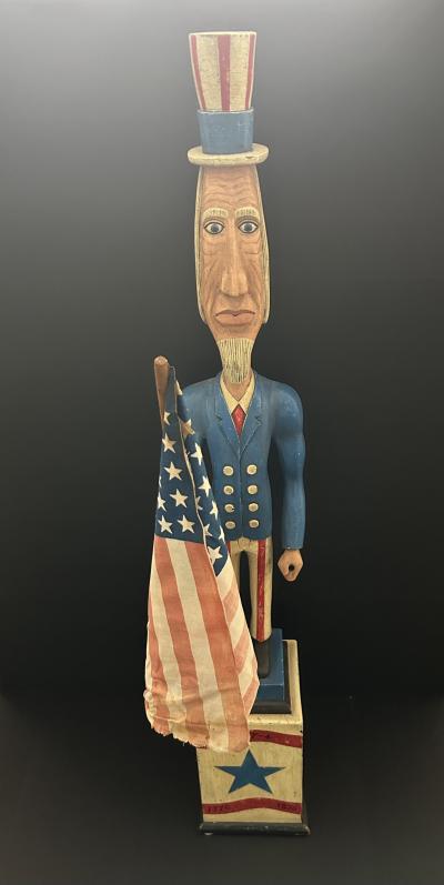 A CARVED AND PAINTED FIGURE OF UNCLE SAM CIRCA 1876