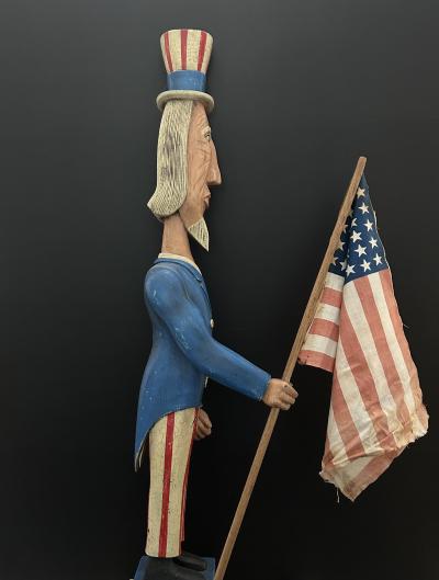 A CARVED AND PAINTED FIGURE OF UNCLE SAM CIRCA 1876