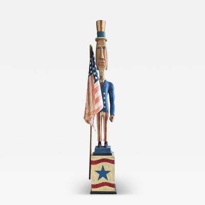 A CARVED AND PAINTED FIGURE OF UNCLE SAM CIRCA 1876