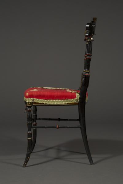 A CHARMING PAIR OF BLACK LACQUER AND POLYCHROME PAINTED CHINOISERIE SIDE CHAIRS