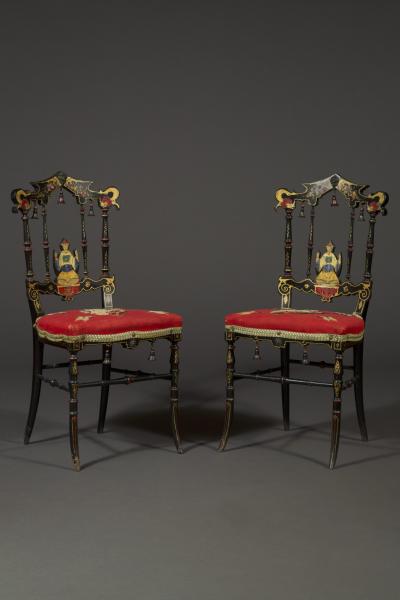 A CHARMING PAIR OF BLACK LACQUER AND POLYCHROME PAINTED CHINOISERIE SIDE CHAIRS