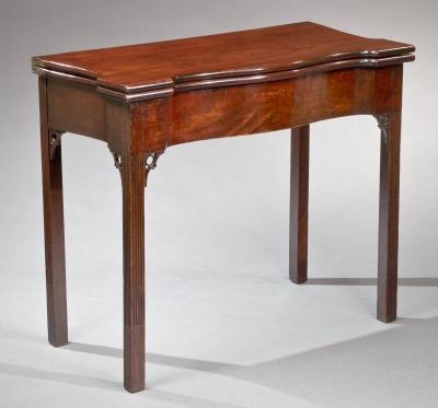 A CHIPPENDALE SERPENTINE FRONT STOP FLUTED CARD