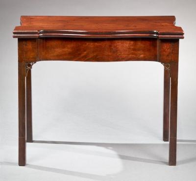 A CHIPPENDALE SERPENTINE FRONT STOP FLUTED CARD