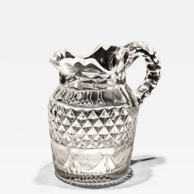 A CUT GLASS IRISH CREAM JUG