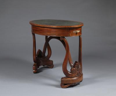 A Charles X Carved Mahogany Oval Writing Table of Unusual Form