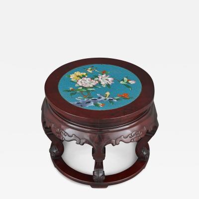 A Chinese cloisonn enamel inset circular carved hardwood pedestal