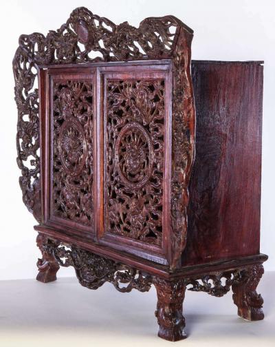 A Chinese small openwork wood cabinet depicting Dragons