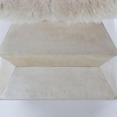 A Contemporary parchment covered stool having goat hair upholstery 