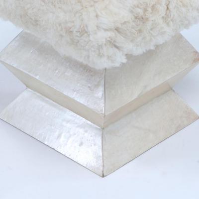 A Contemporary parchment covered stool having goat hair upholstery 