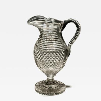 A DIAMOND STEP CUT PEDESTAL WATER JUG