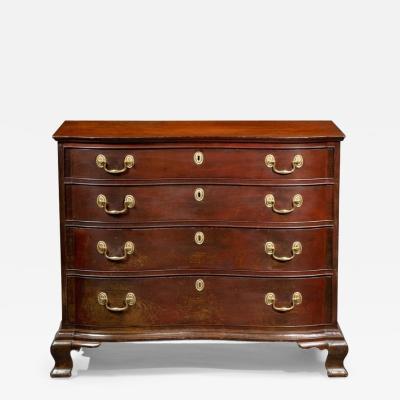 A FINE CHIPPENDALE OXBOW CHEST OF DRAWERS