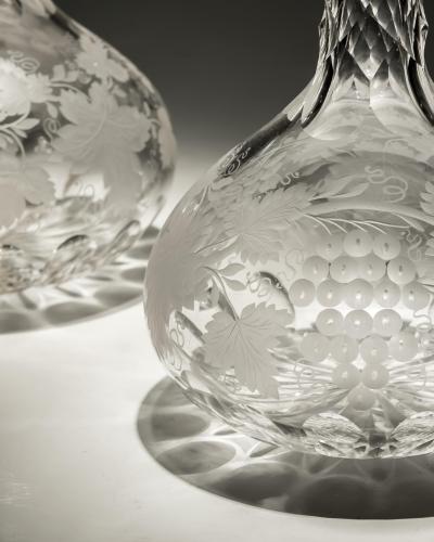 A FINE PAIR OF ENGRAVED SHAFT GLOBE DECANTERS