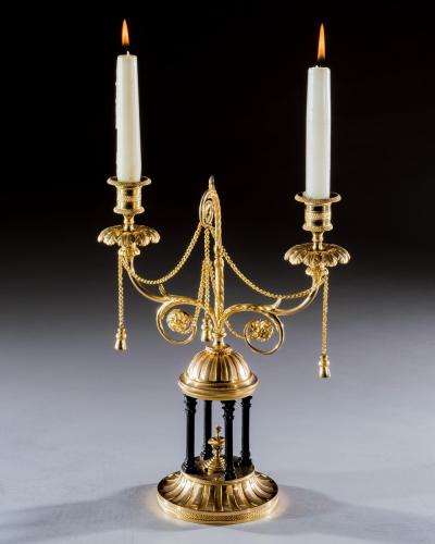 A FINE PAIR OF ORMOLU AND BRONZE TEMPLE CANDELABRA