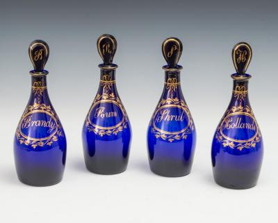 A FINE SET OF FOUR BRISTOL BLUE GILT LABEL ANTIQUE GEORGIAN DECANTERS