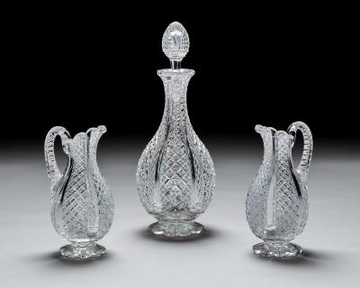 A FINELY CROSSOVER DIAMOND CUT DECANTER WITH MATCHING PAIR OF JUGS