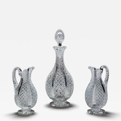 A FINELY CROSSOVER DIAMOND CUT DECANTER WITH MATCHING PAIR OF JUGS