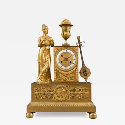 A FRENCH GILT BRONZE EMPIRE STYLE MANTEL CLOCK EARLY 19TH CENTURY