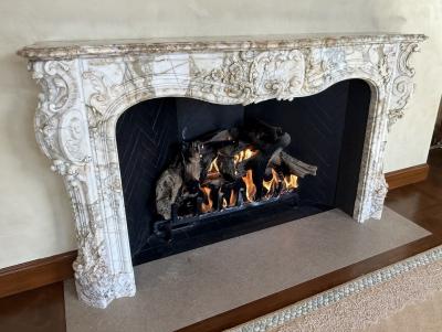 A Finely Carved Louis XV Style Fireplace Mantel in Figured Italian Marbl