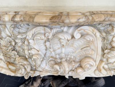 A Finely Carved Louis XV Style Fireplace Mantel in Figured Italian Marbl