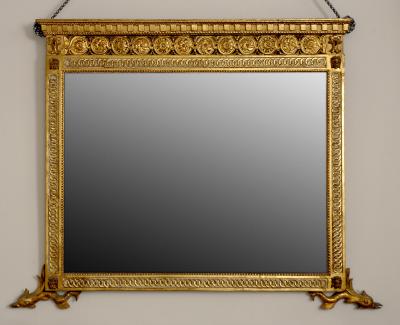 A Finely Carved and Gilded Mirror with Dolphin Feet