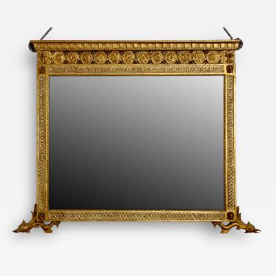 A Finely Carved and Gilded Mirror with Dolphin Feet