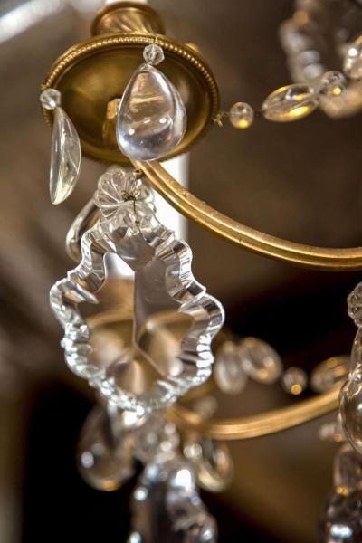A Finely Cast Bronze and Crystal Eight Arm Chandelier