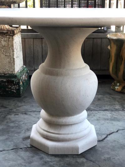 A French Carved Limestone Circular Table on a Baluster form Base