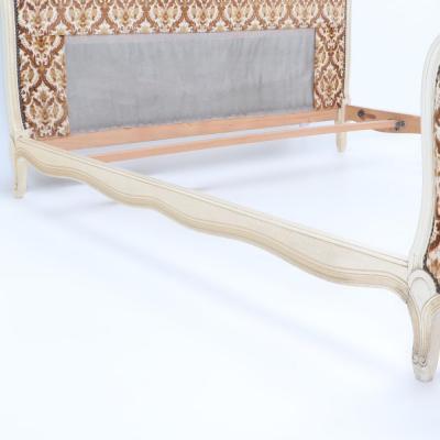 A French Louis XV style full size bed having a curved footboard C 1920