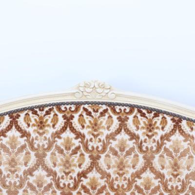 A French Louis XV style full size bed having a curved footboard C 1920