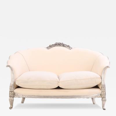 A French Louis XV style silver leaf carved settee C 1930 