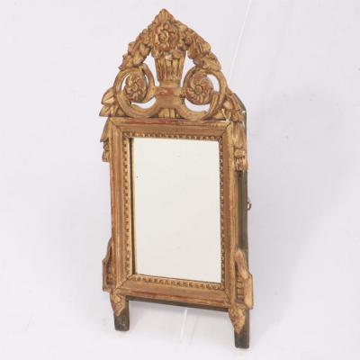 A French Louis XVI style carved and giltwood mirror C 1810 