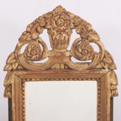 A French Louis XVI style carved and giltwood mirror C 1810 