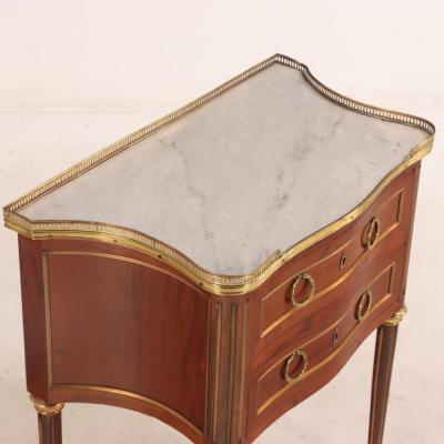 A French Louis XVI style mahogany petite marble top commode C 1910 