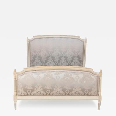 A French Louis XVI style painted and upholstered full size bed C 1940 