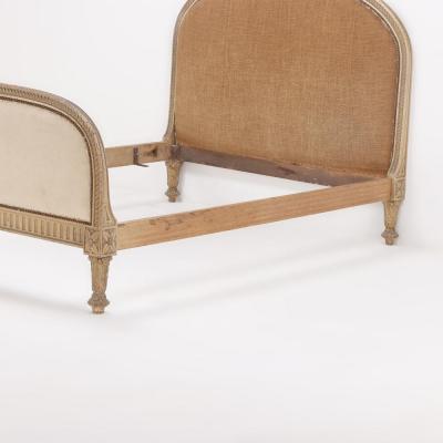 A French painted and carved full size bed in the Regency style C 1900 