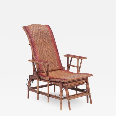 A French rattan Chaise Longue with orange and red stripes circa 1900 