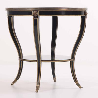 A French round marble top ebonized and gilt table C 1940 
