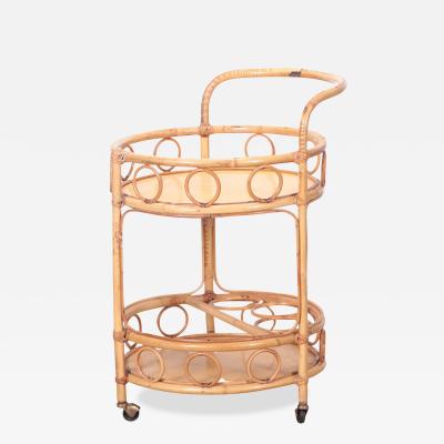 A French two tier rattan bar cart on wheels Circa 1960