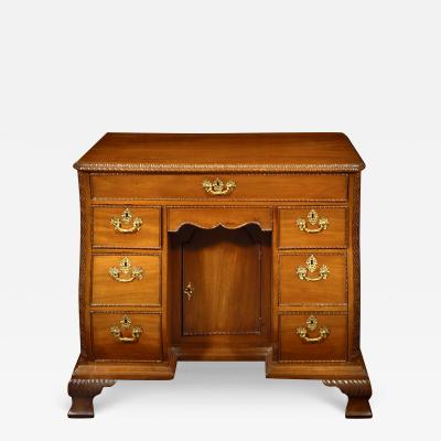 A GEORGE III STYLE MAHOGANY KNEEHOLE CHEST