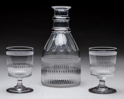 A GEORGIAN BROAD FINE FLUTE MAGNUM CARAFE AND MATCHING GLASSES