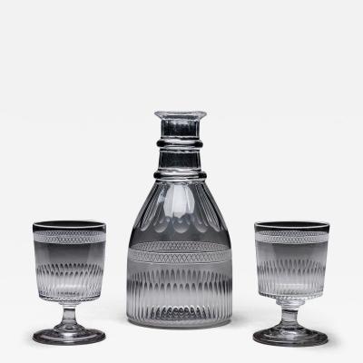 A GEORGIAN BROAD FINE FLUTE MAGNUM CARAFE AND MATCHING GLASSES