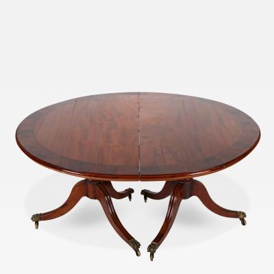 A George III Two Part Tilting Demi Lune Section Mahogany Dining Table