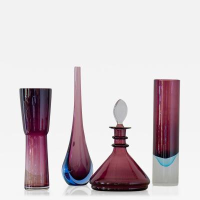 A Group of Four Plum Purple Glass Vases