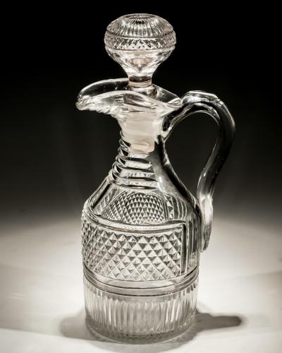 A HEAVILY CUT REGENCY CLARET JUG