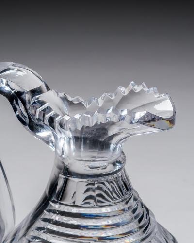 A HEAVILY CUT REGENCY CLARET JUG