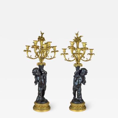 A High Quality Pair of Patinated and Gilt Bronze Figural Candelabras