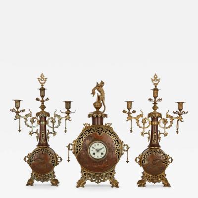 A Japonisme gilt bronze and brass three piece clock set