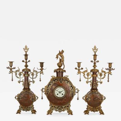 A Japonisme gilt bronze and brass three piece clock set